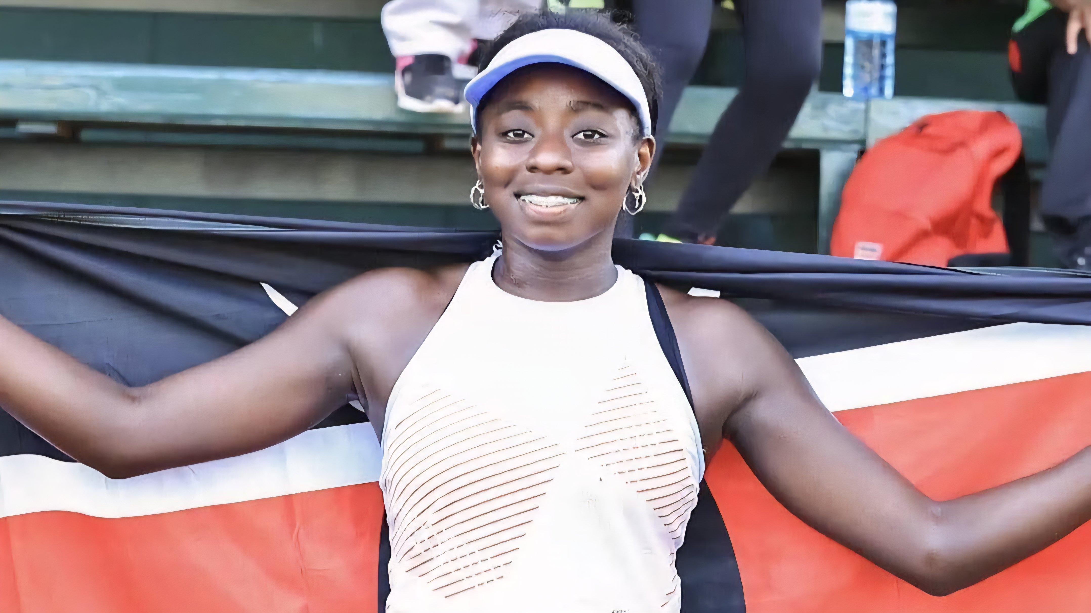 Angella Okutoyi standing on a tennis court after winning the International Tennis Federation Women's World Tour final.