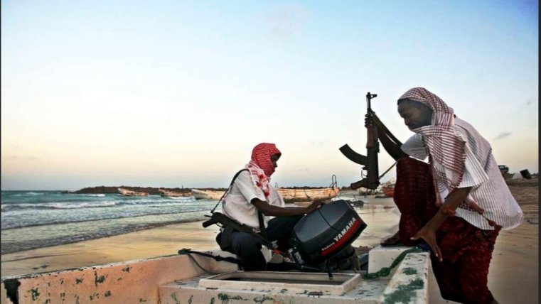 Armed Somali pirates preparing skiffs in Hobyo for attacks in the Gulf of Aden