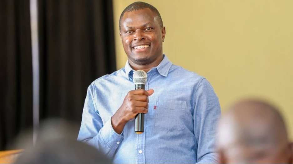 Kiharu MP Ndindi Nyoro speaking into a microphone during a public address.
