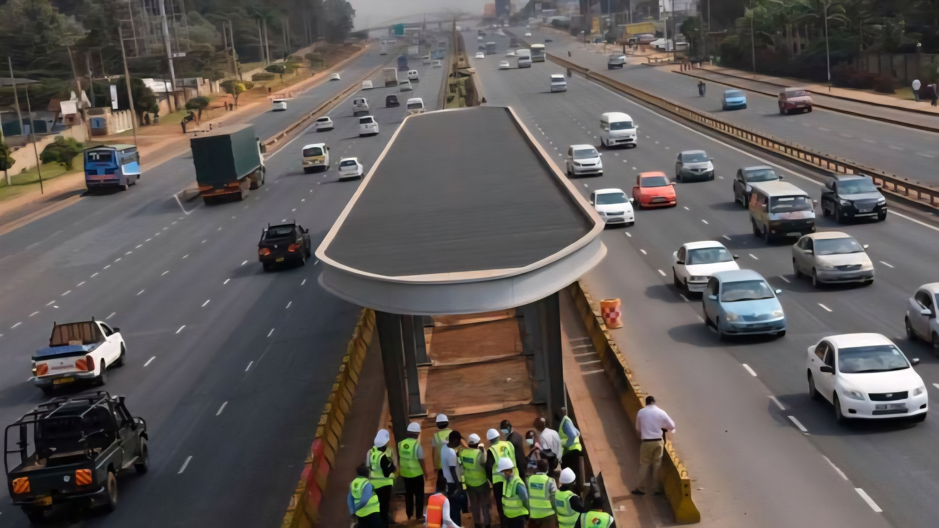 An aerial view of a dedicated Bus Rapid Transit station and lane constructed along a multi-lane highway in Nairobi, Kenya.