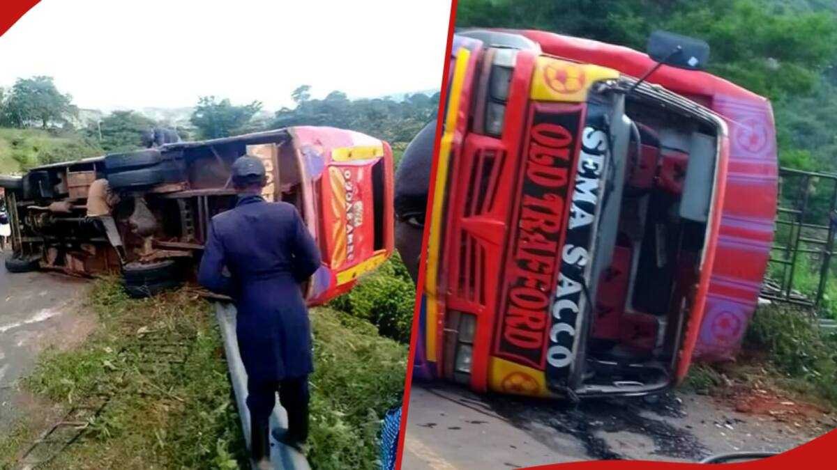 Damaged red and green bus resting on its side along the Emali-Ukia road following a fatal accident in Makueni County.