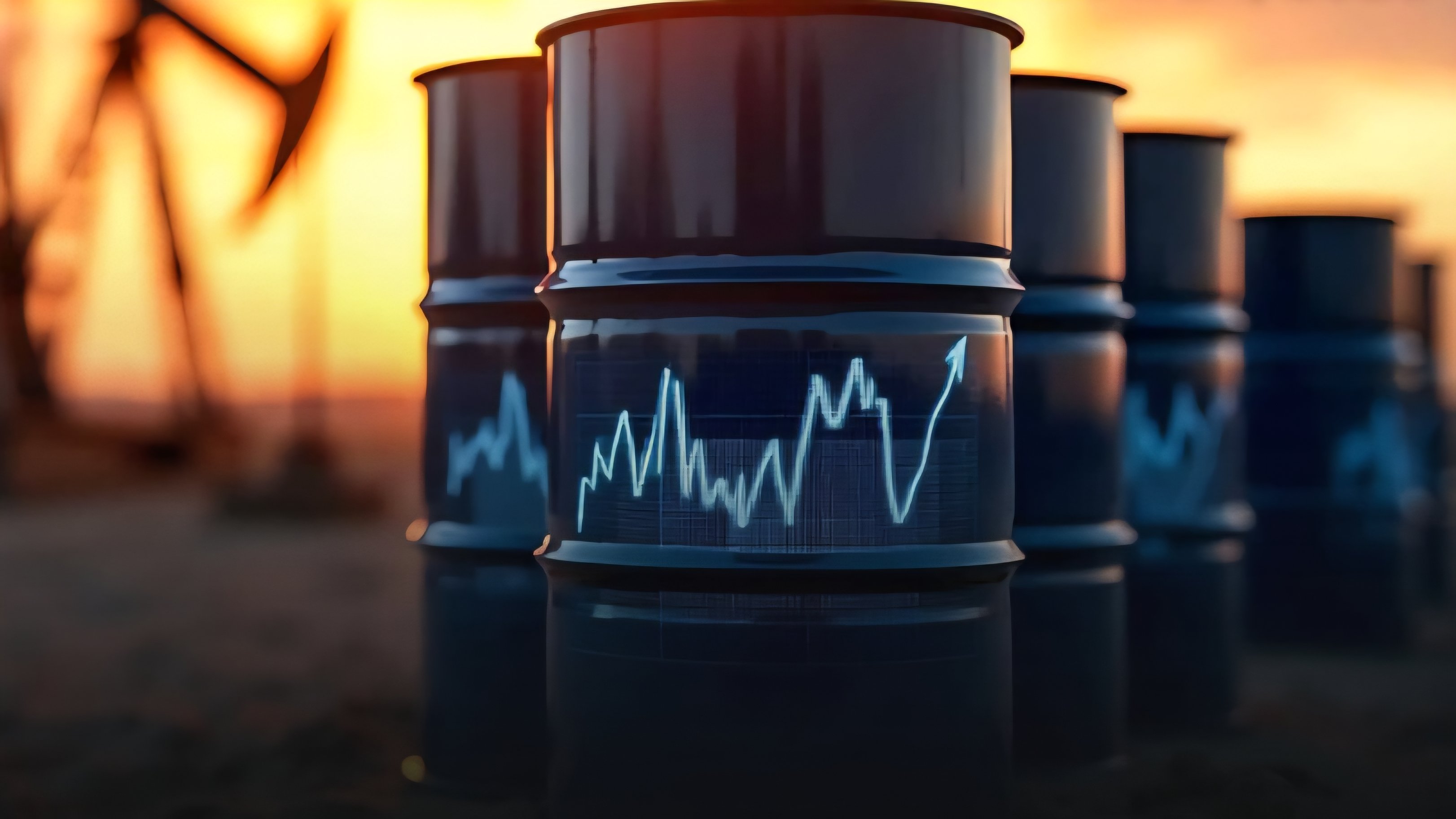 Close-up of three black oil barrels with a glowing orange sunset and oil derricks in the background, featuring a blue line graph indicating price fluctuations.