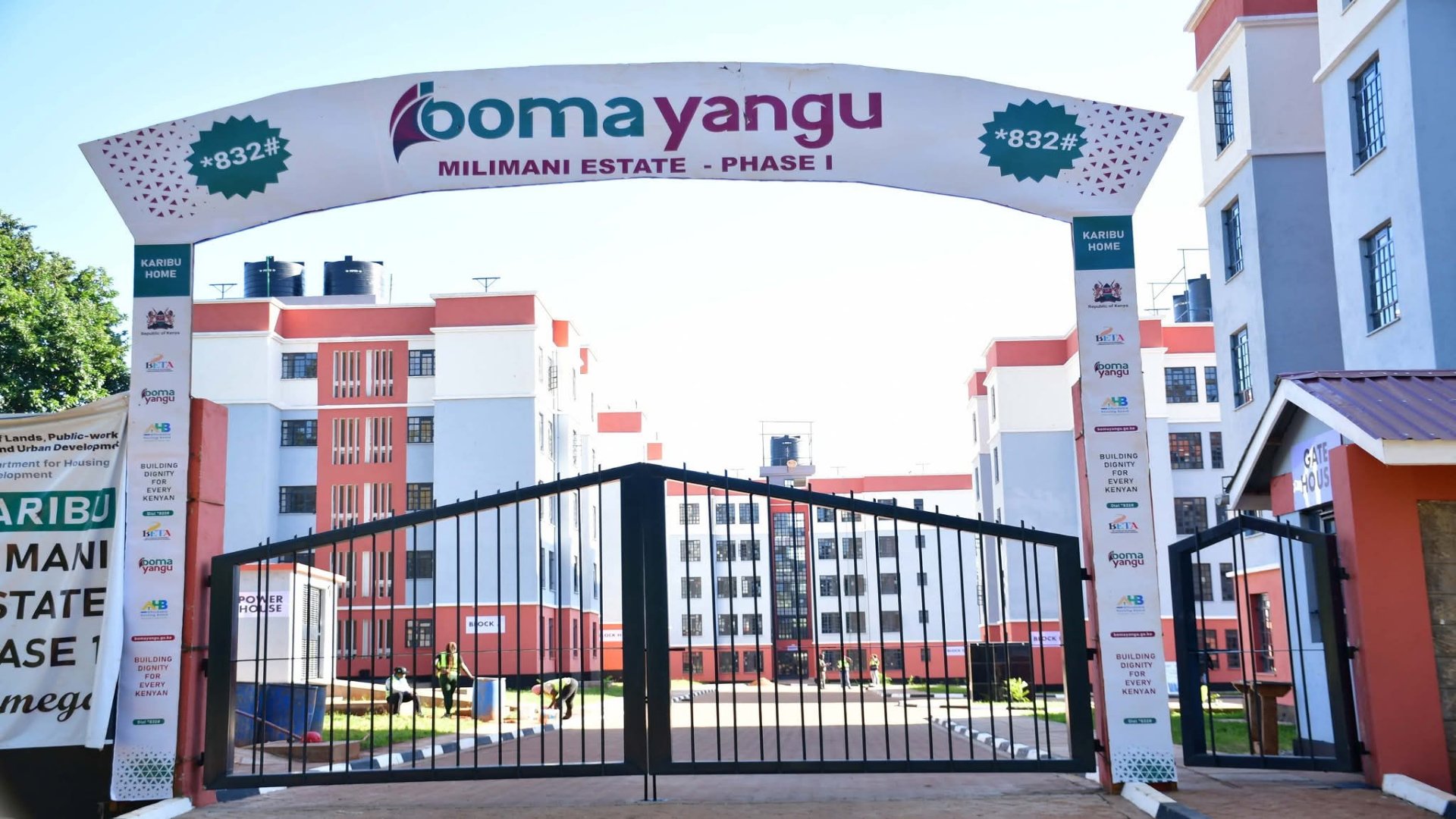 A gated community of newly completed multi-story residential apartment blocks with modern finishes and paved parking areas at the Milimani Estate in Kakamega.