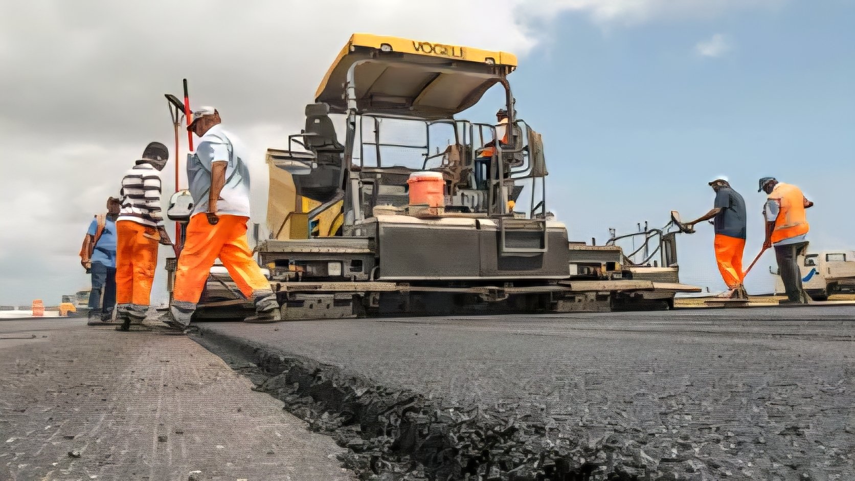 Road construction crew laying asphalt on a public highway project in Kenya.