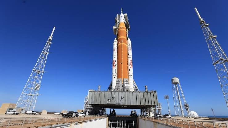 The 322-foot-tall Space Launch System rocket for the Artemis II mission stands on the mobile launcher at Launch Complex 39B under a clear sky.