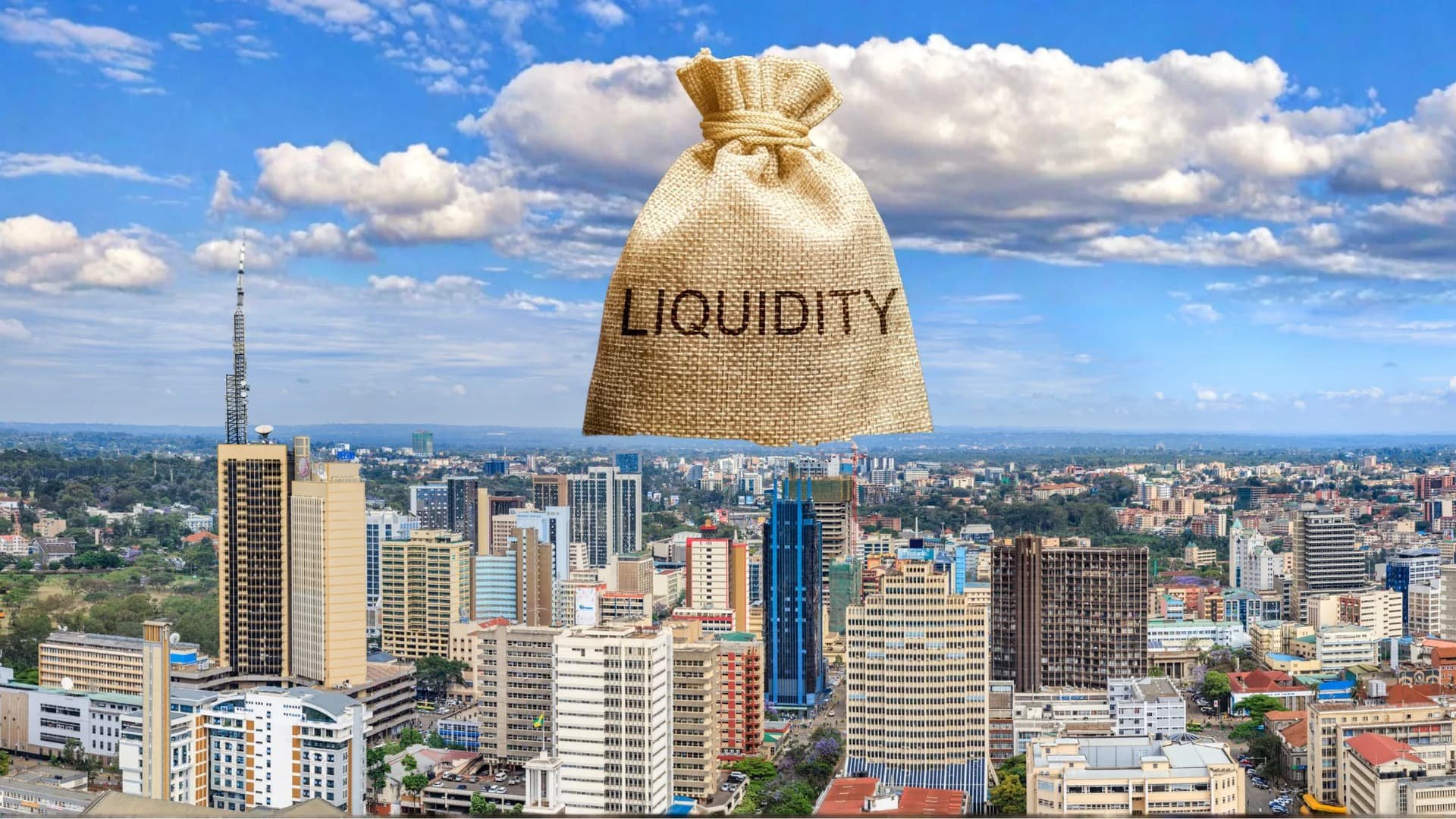A wide-angle aerial view of the Nairobi city skyline under a blue sky with white clouds, featuring prominent skyscrapers and the iconic Times Tower.