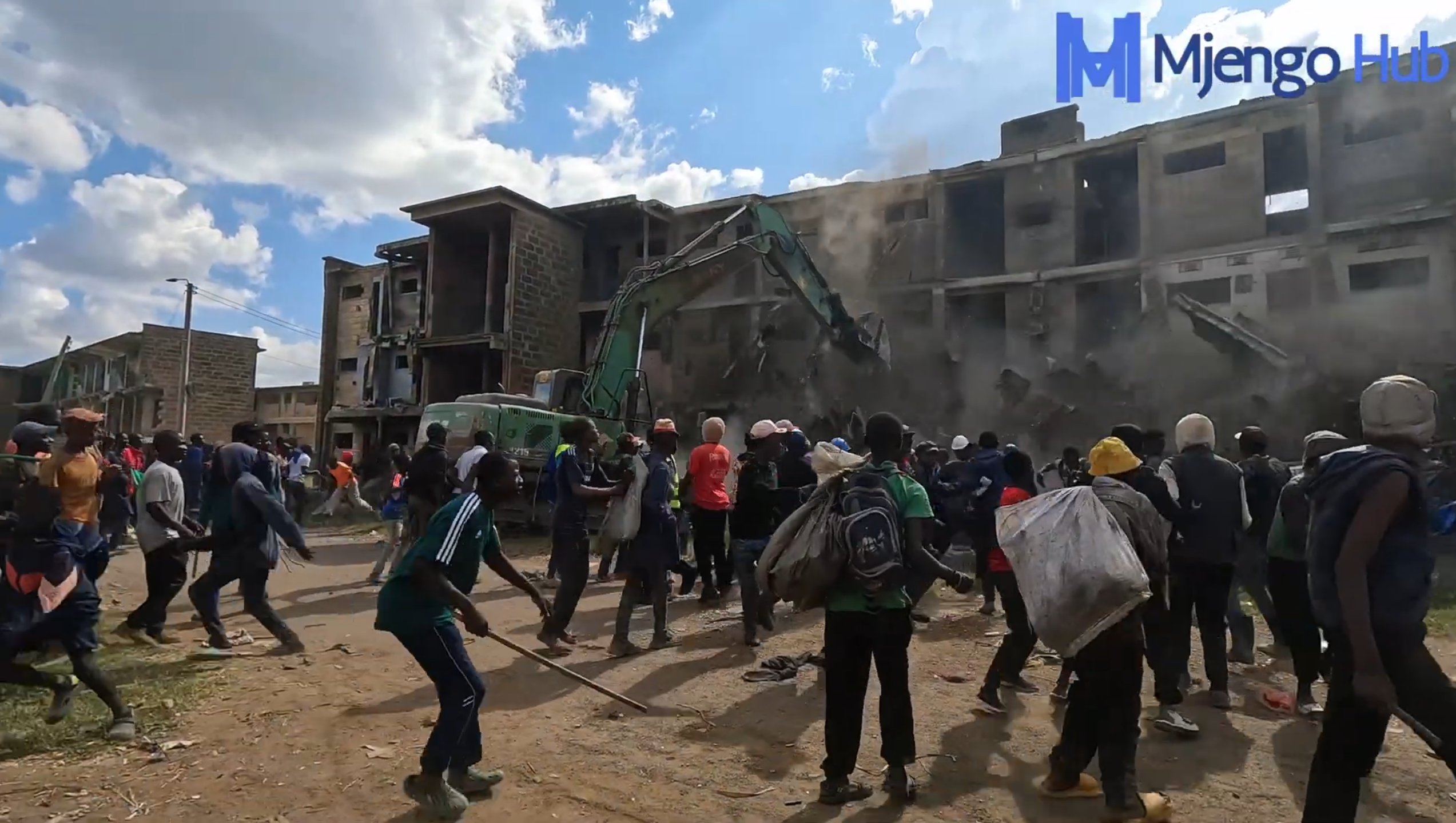 Residents salvage their belongings as heavy machinery clears debris at Makongeni Estate on November 22, 2025, as the government begins construction of 30,000 new affordable housing units.
