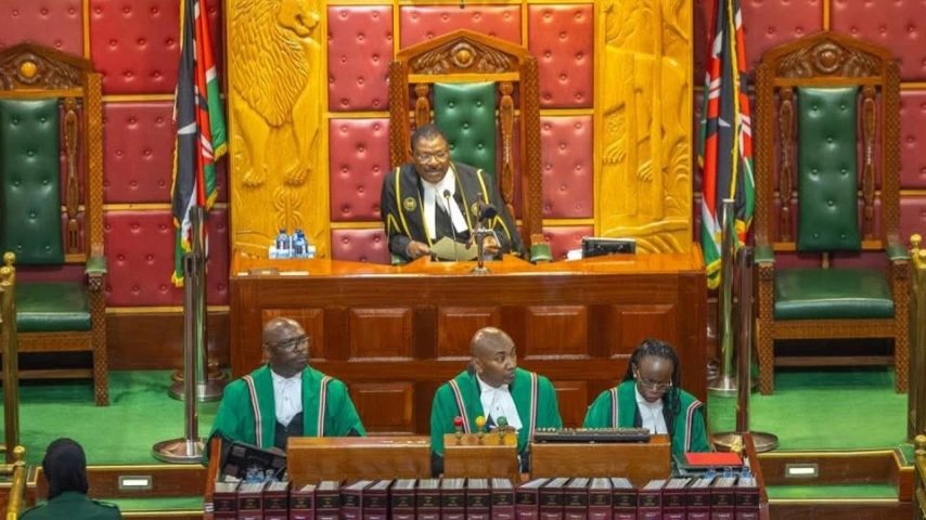 Interior view of the National Assembly of Kenya during a session, showing the Speaker's desk and clerks in traditional robes.