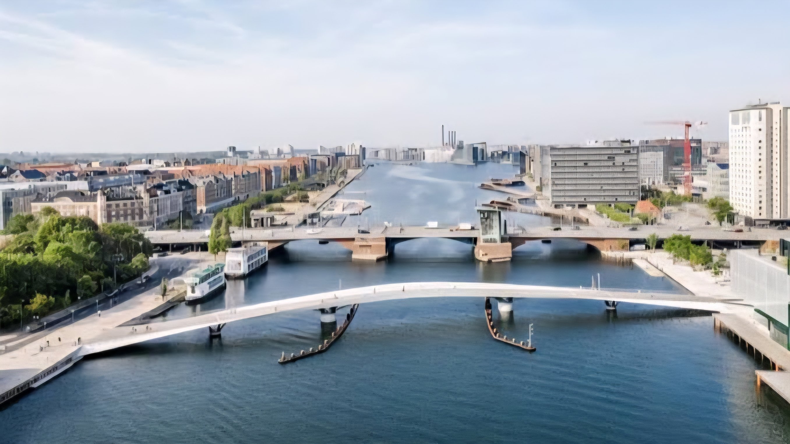 Wide-angle view of a bike path alongside the waterfront harbor in Copenhagen, featuring urban commuters and modern sustainable architectural design under a clear sky.