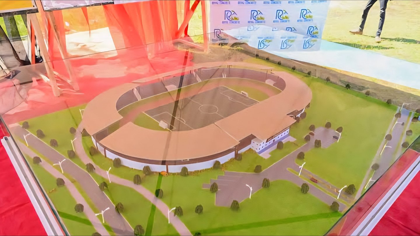 Architectural rendering of the proposed 10,000-seater Moi Stadium in Kisumu showing roofed pavilions and a blue tartan track.
