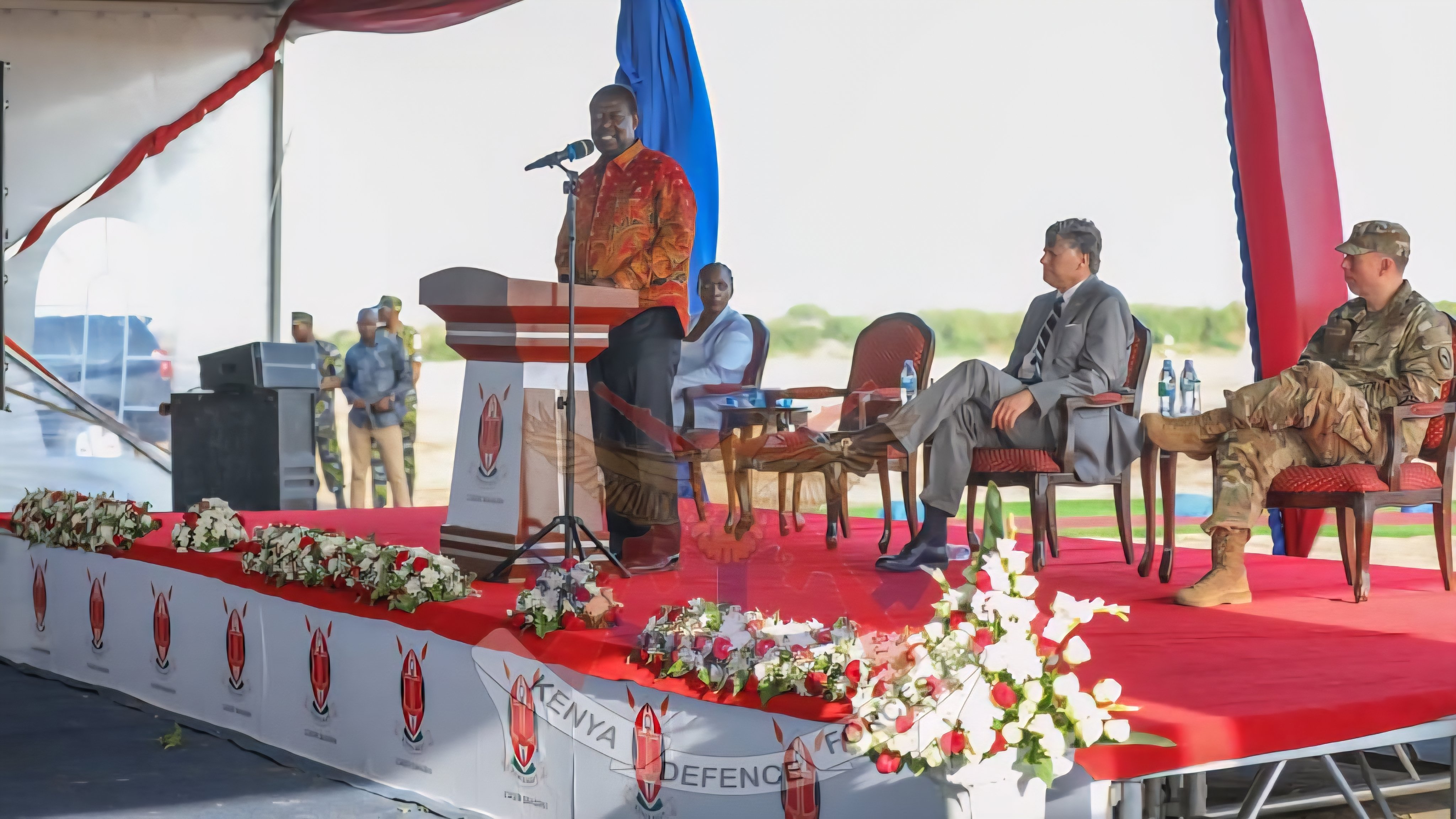 A wide view of the groundbreaking ceremony at the Manda Bay Navy Base in Lamu, showing Kenyan and U.S. officials standing near construction equipment.