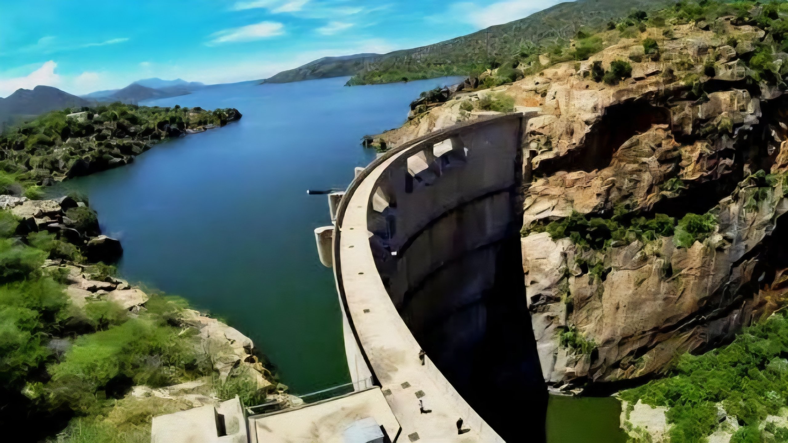 A wide view of the Turkwel Gorge Dam in West Pokot, Kenya, showing the concrete arch structure and the reservoir which will serve as the primary water source for the South Lokichar oil fields.