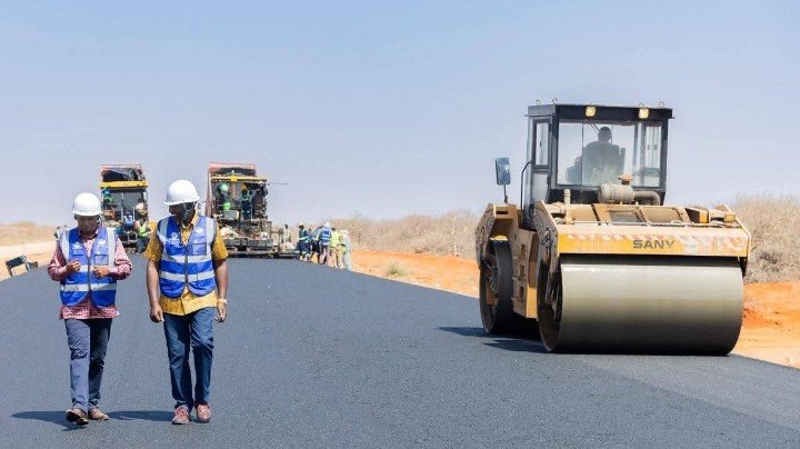 Construction machinery working on a rural road upgrade in Kenya