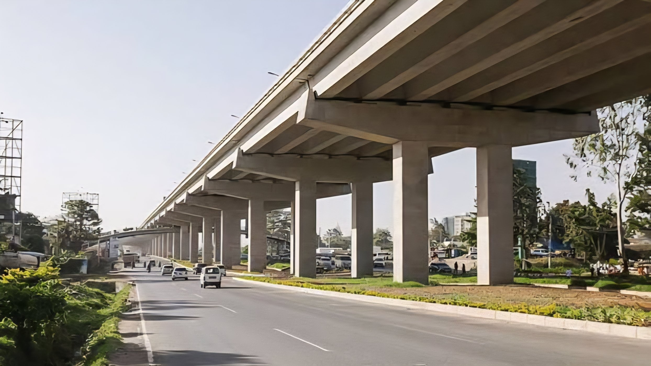 A view from ground level showing the elevated Nairobi Expressway pillars and the lower Mombasa Road during rehabilitation.