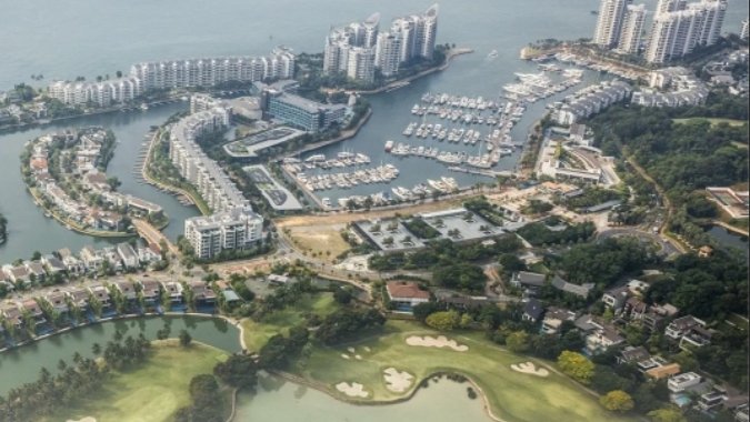 Aerial view of Sentosa Cove luxury residential enclave with marinas, high-rises and waterfront homes in Singapore
