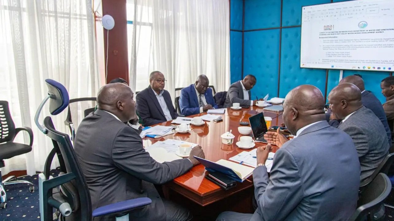Rear view of professionals seated in a conference room during a government briefing session in Kenya.