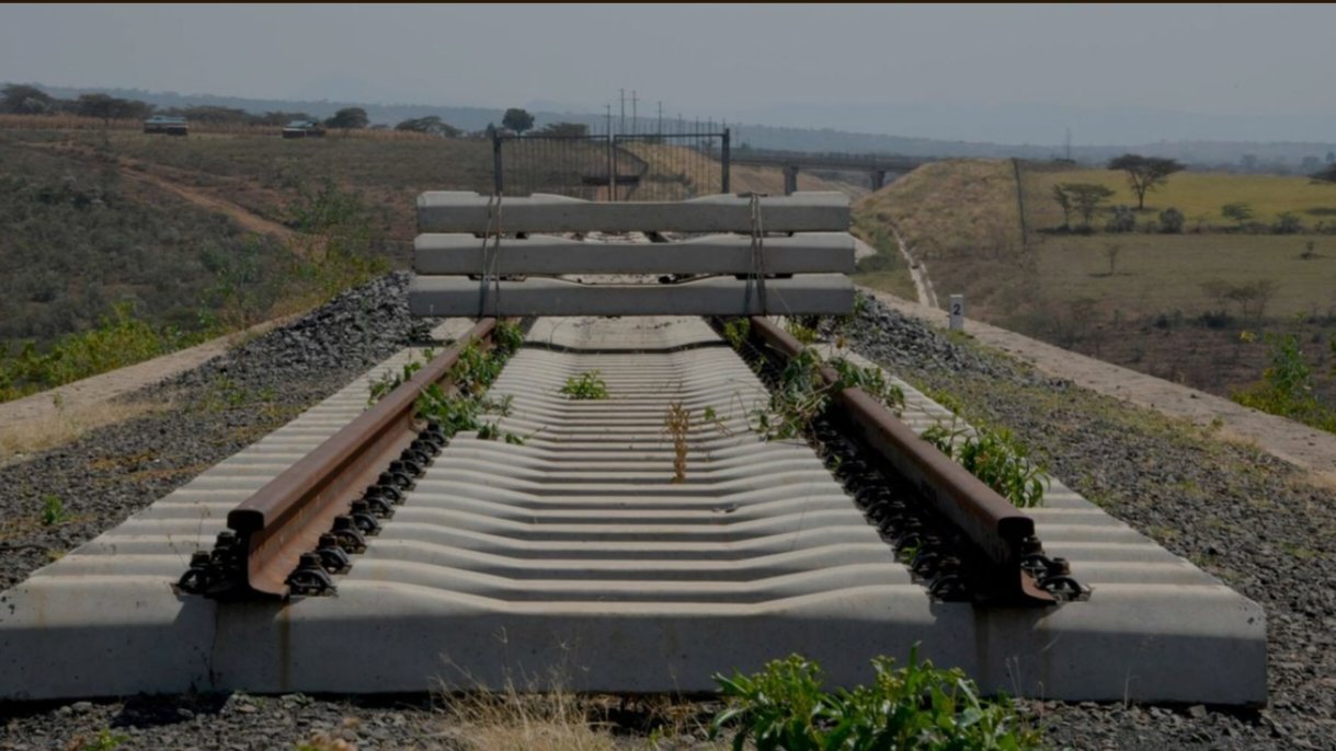 A segment of the Standard Gauge Railway tracks ending abruptly in the dry landscape of Suswa, Naivasha, with concrete sleepers stacked on the line.