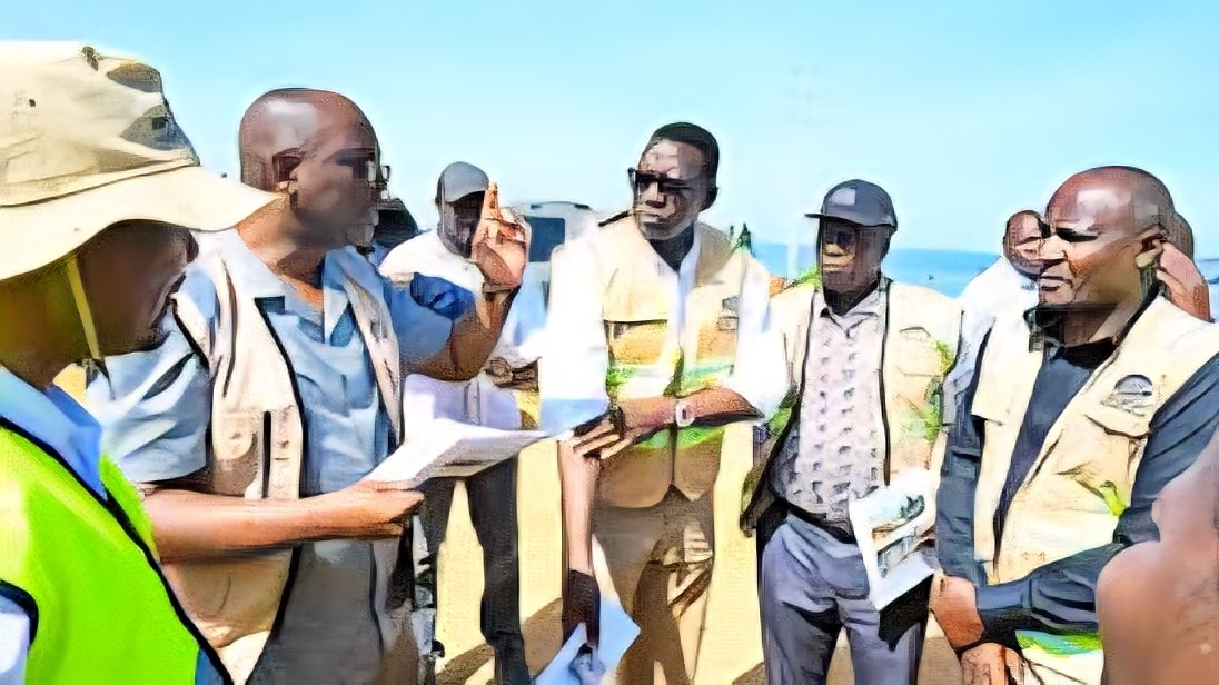 Cabinet Secretary Davis Chirchir and KeNHA officials standing at a construction site along a road project in Kenya.