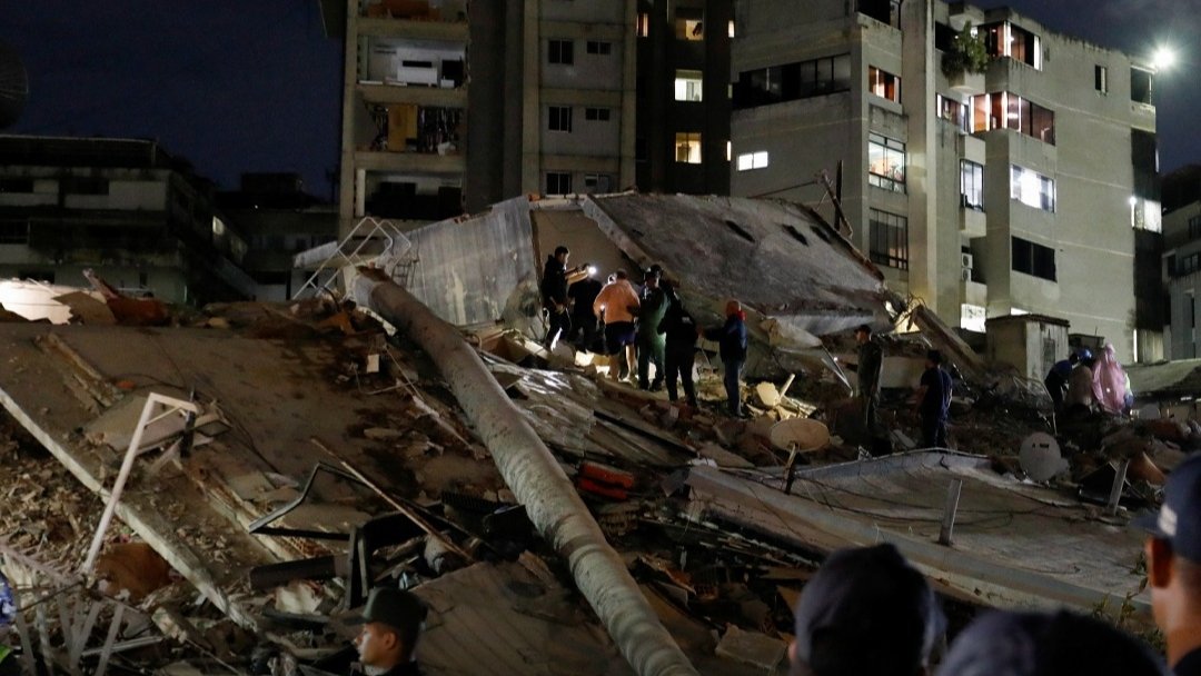 Damaged buildings and rescue teams in Caracas following strong earthquakes in Venezuela.