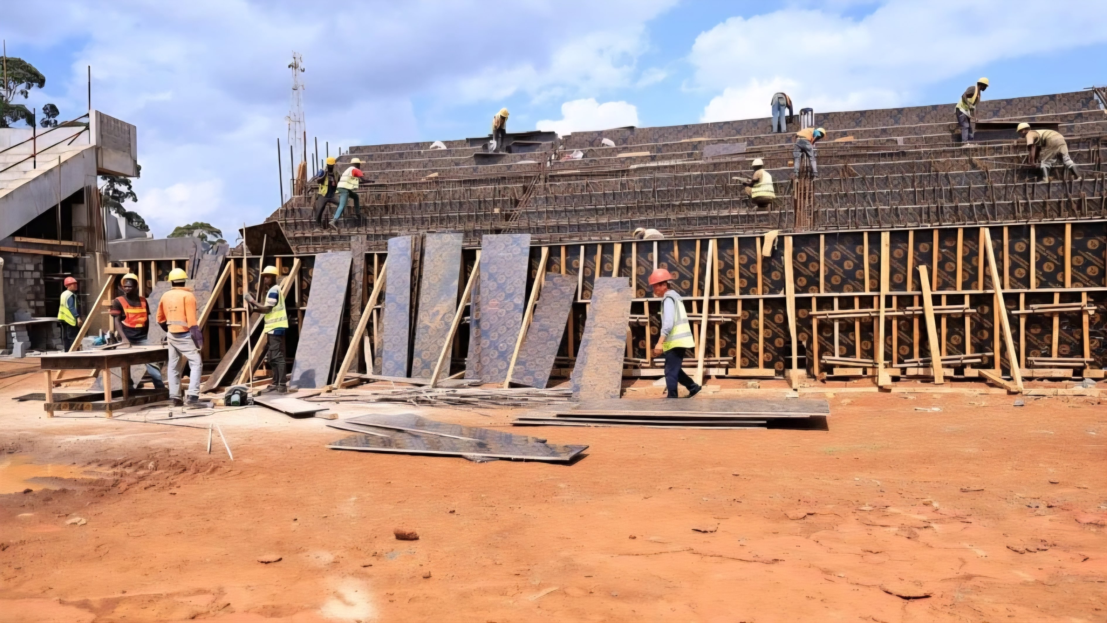Construction workers installing wooden formwork and steel reinforcement for the concrete terraces at the Kipchoge Keino Stadium site in Eldoret.