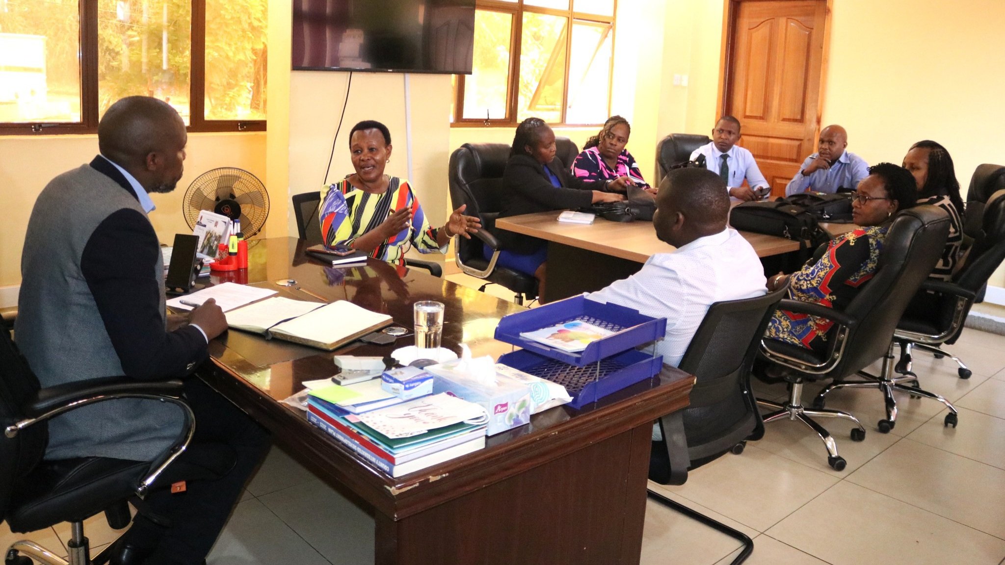A high-level consultative meeting between Kiambu County Department of Housing officials and the Council of Governors representatives seated around a boardroom table to discuss KUSP II urban development funding.
