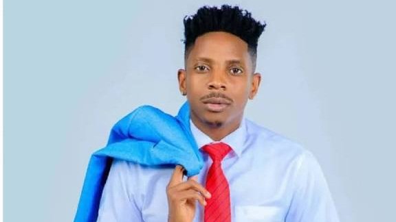 A promotional graphic featuring Eric Omondi in a white shirt and red tie, with a circular inset showing workers in green uniforms and yellow helmets performing a manual cleaning task in a waterway