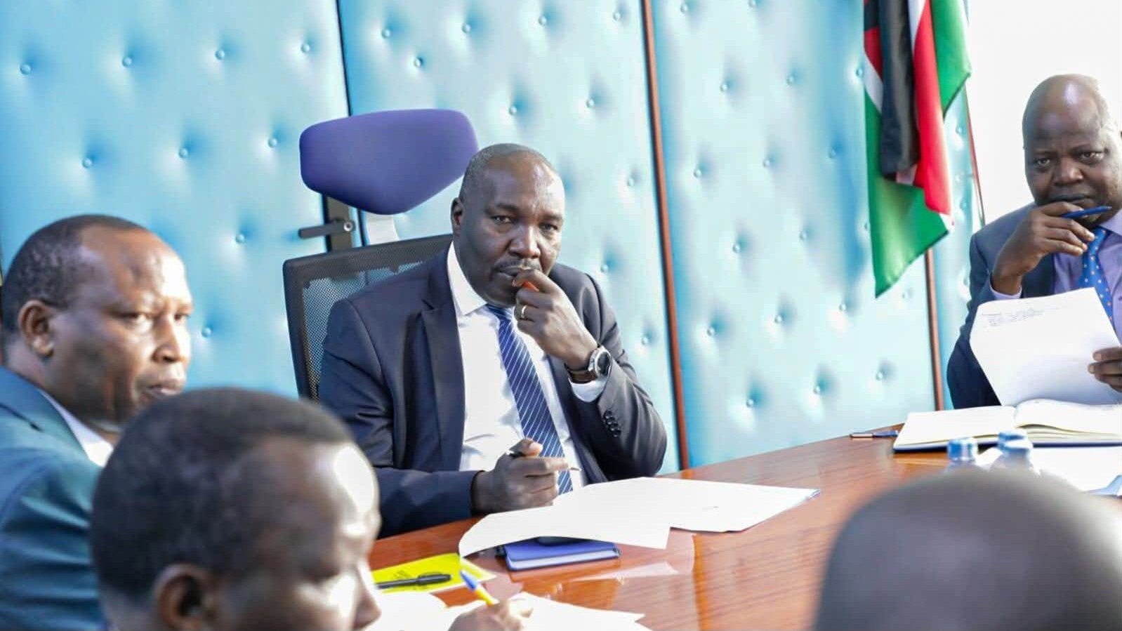 Principal Secretary Julius Korir and Water Secretary Samwel Alima sitting at a conference table during a meeting.