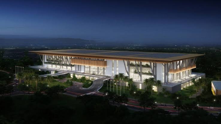 An architectural rendering of a large, modern circular convention centre with glass facades and landscaped grounds at the Bomas of Kenya site.