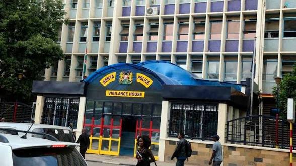 Exterior view of Vigilance House, the Kenya Police Service headquarters in Nairobi, showing the blue arched entrance and the national coat of arms.