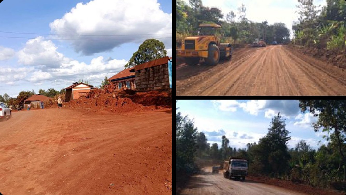 Heavy construction equipment compacting an unpaved road corridor under a cloudy sky in Kenya.