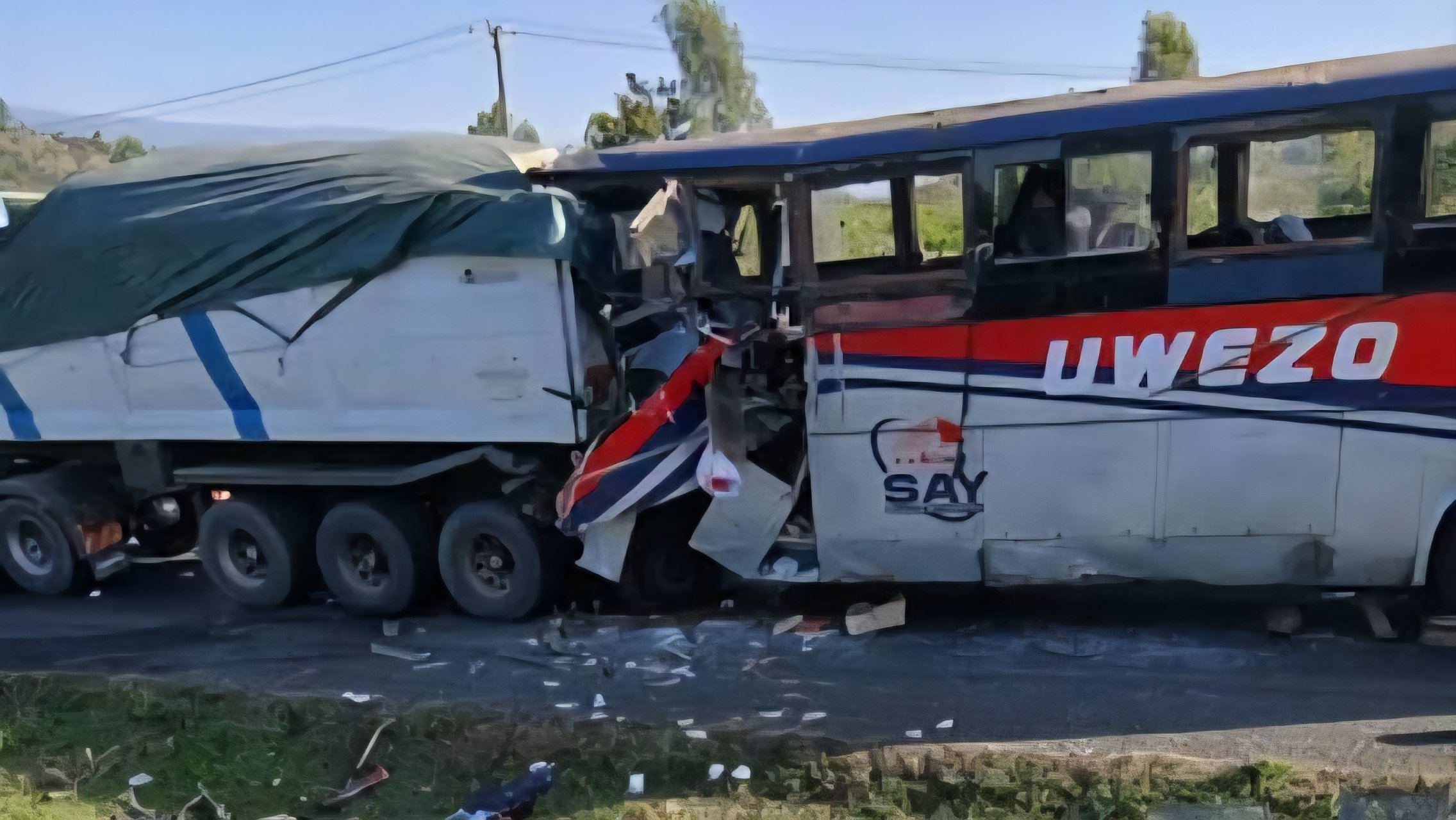 The scene of a head-on collision between a white truck and a bus on a paved highway along Londiani-Muhoroni road.