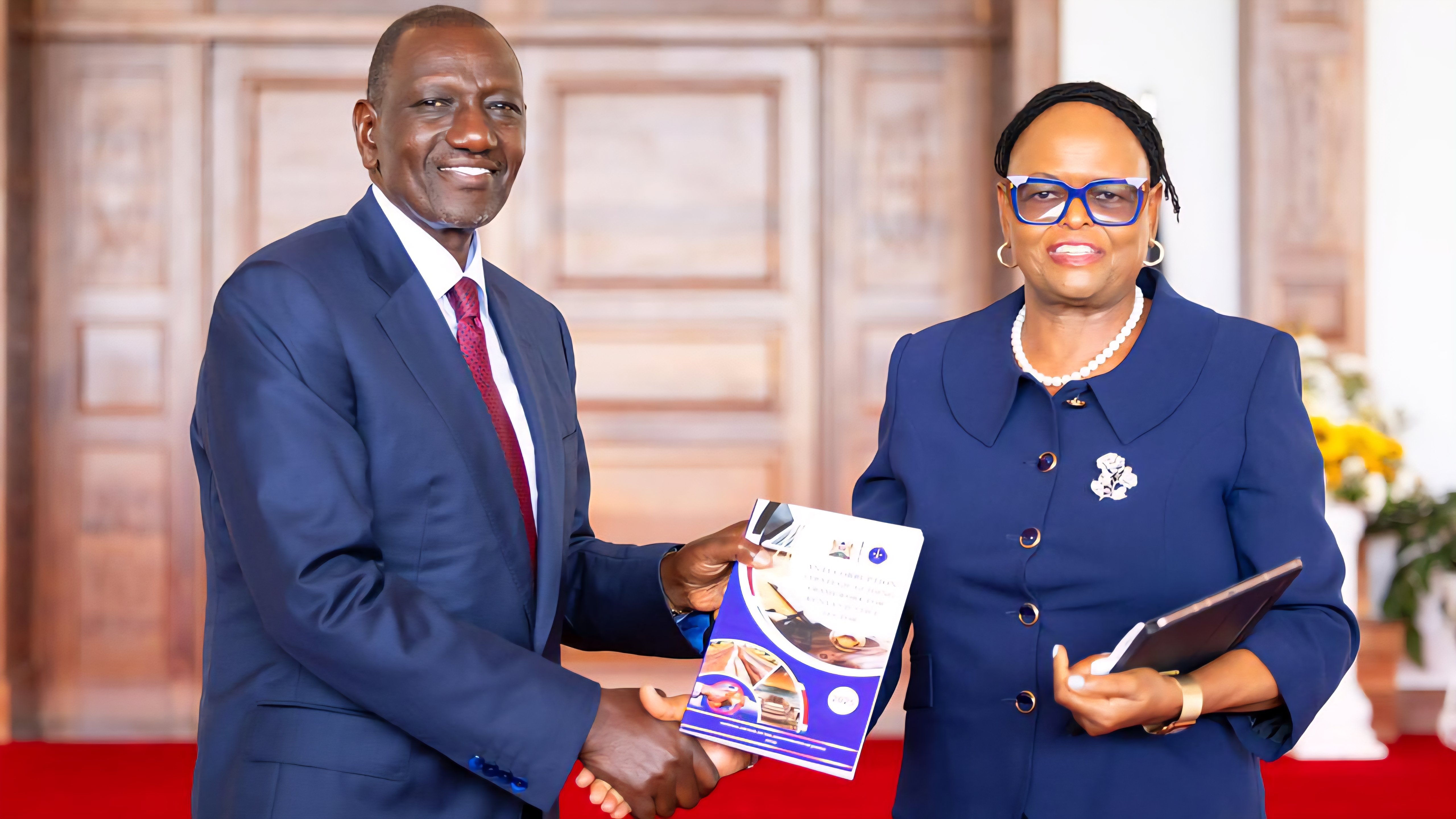 President William Ruto receiving a report on traffic accidents from Chief Justice Martha Koome at State House, Nairobi.
