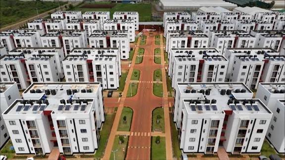 An expansive green landscape within the Tatu City development showing a mix of natural vegetation and distant construction.