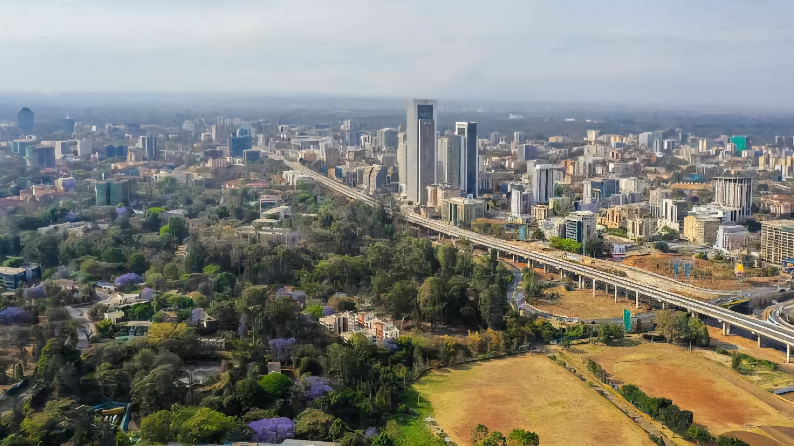 A wide-angle view of an expansive, undeveloped plot of public land in Kenya with a city skyline visible in the distance under a clear sky.