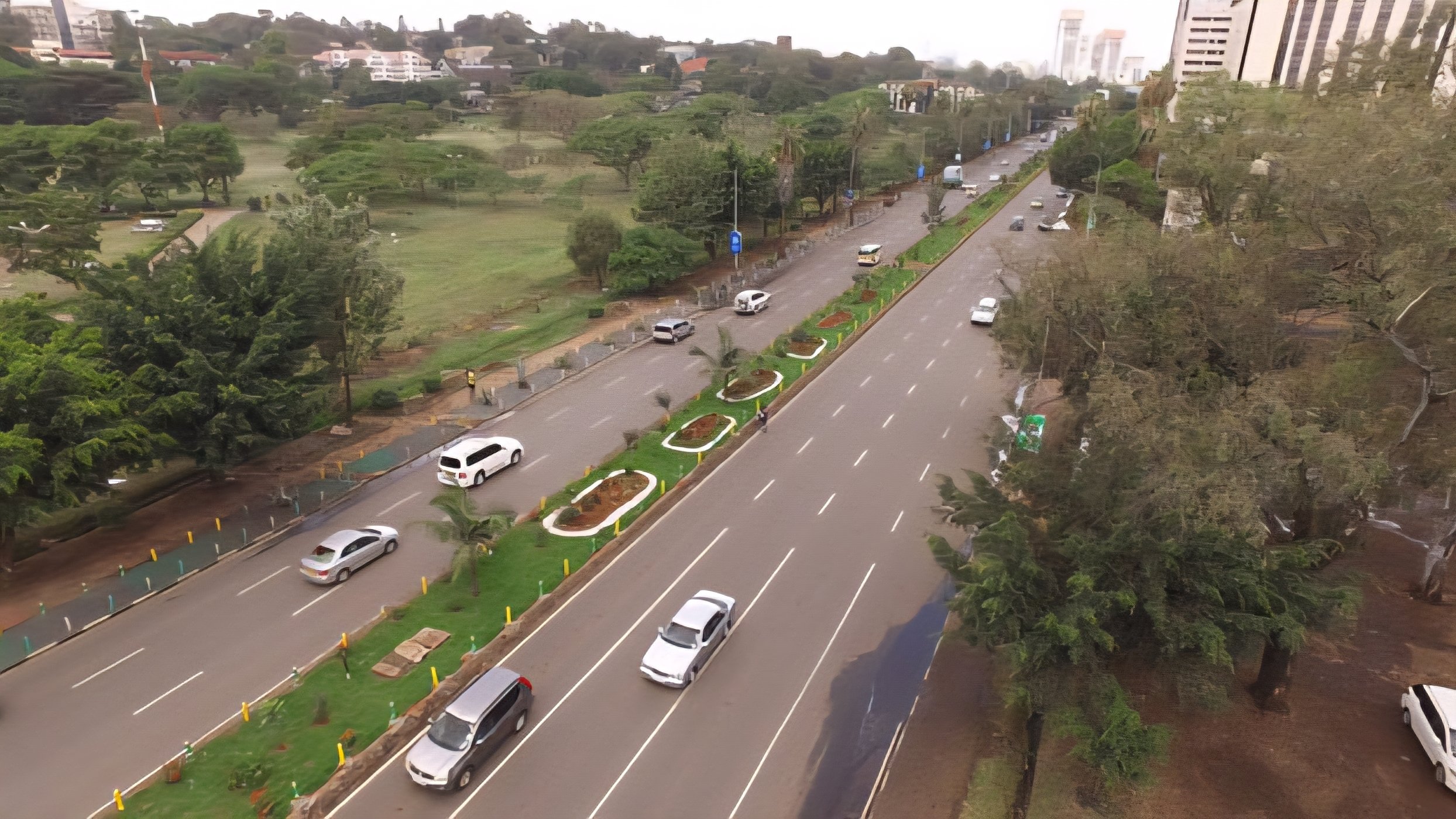 Aerial view of the lower Mombasa Road highway being re-carpeted beneath the Nairobi Expressway viaduct, symbolizing the JKIA to Westlands rehabilitation project.