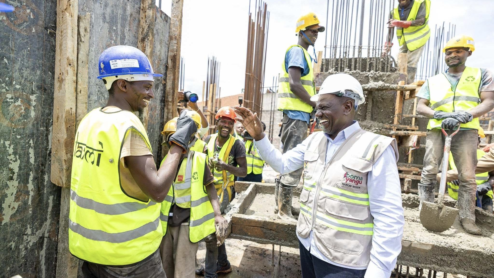 President William Ruto interacting with construction workers at an Affordable Housing Programme site.
