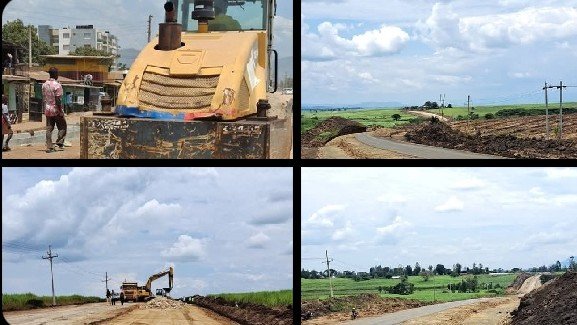 Long view of significant earth-moving and stockpiling along the Miwani-Chemelil road, highlighting the scale of works to improve transport for the sugar industry and local communities.