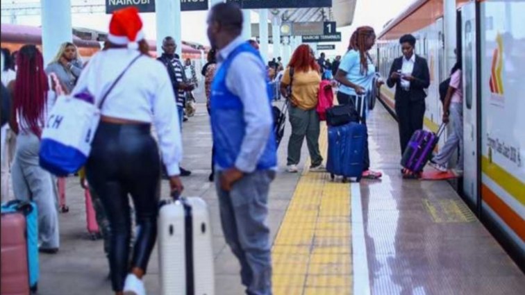 Passengers with luggage at Nairobi railway station platform
