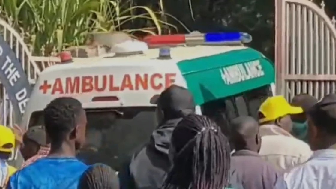 A crowd of people and an ambulance gathered at the scene of the septic tank collapse at Kapsabet School for the Deaf.