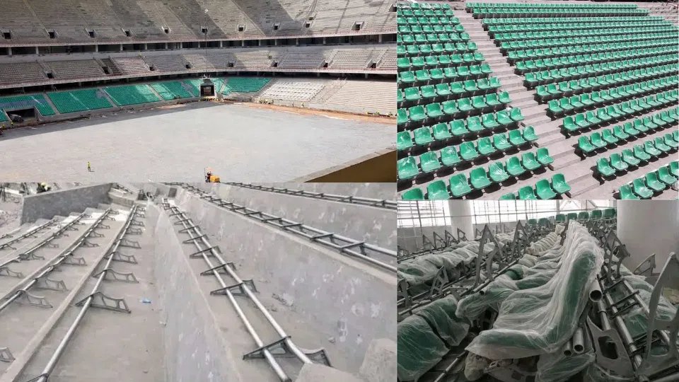 Close-up view of newly installed plastic stadium seats in the stands of a large construction site.