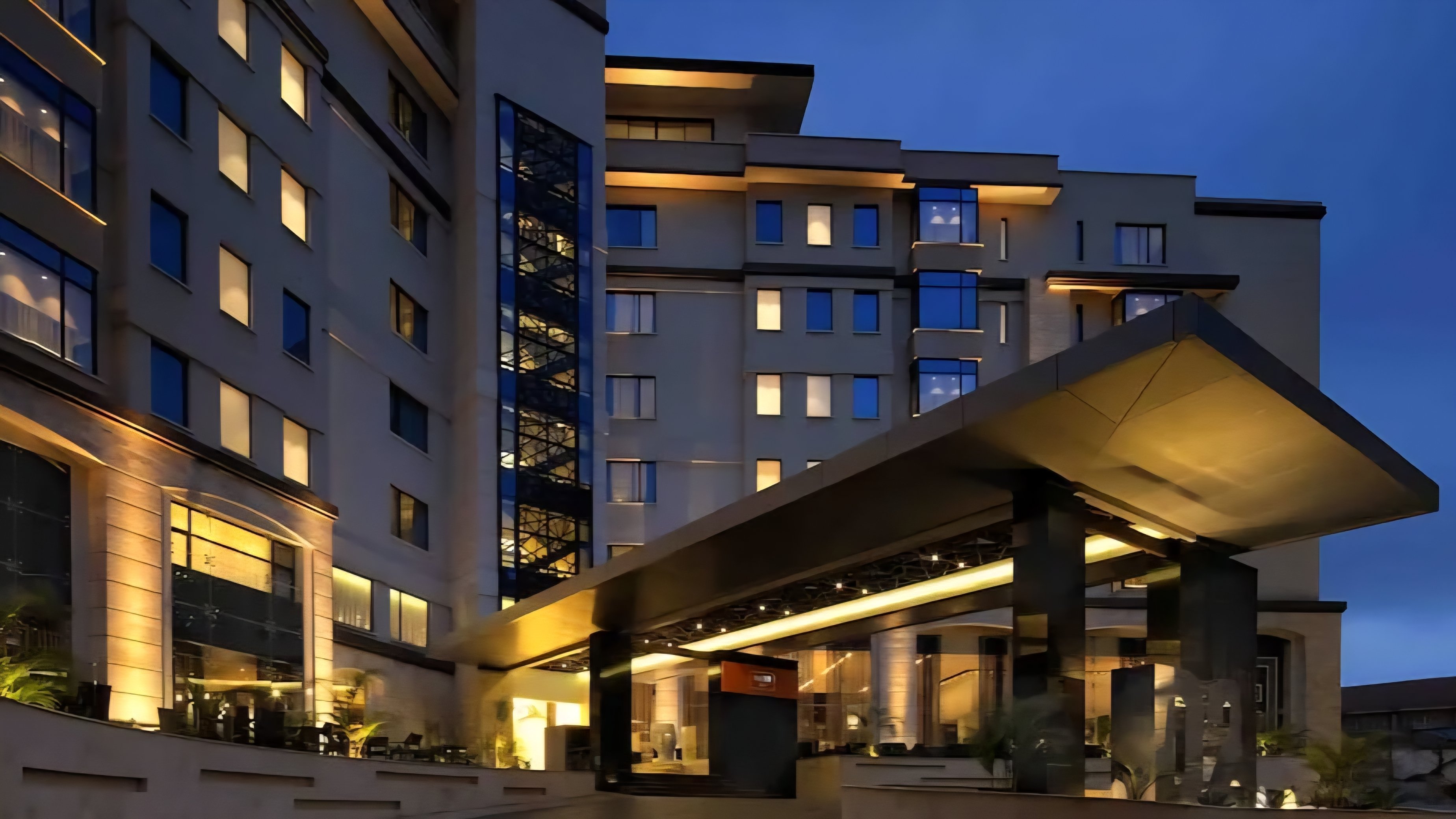 A digital screenshot of a news report from file 290821.png showing the 14 Riverside commercial complex entrance in Nairobi with vehicles parked outside.