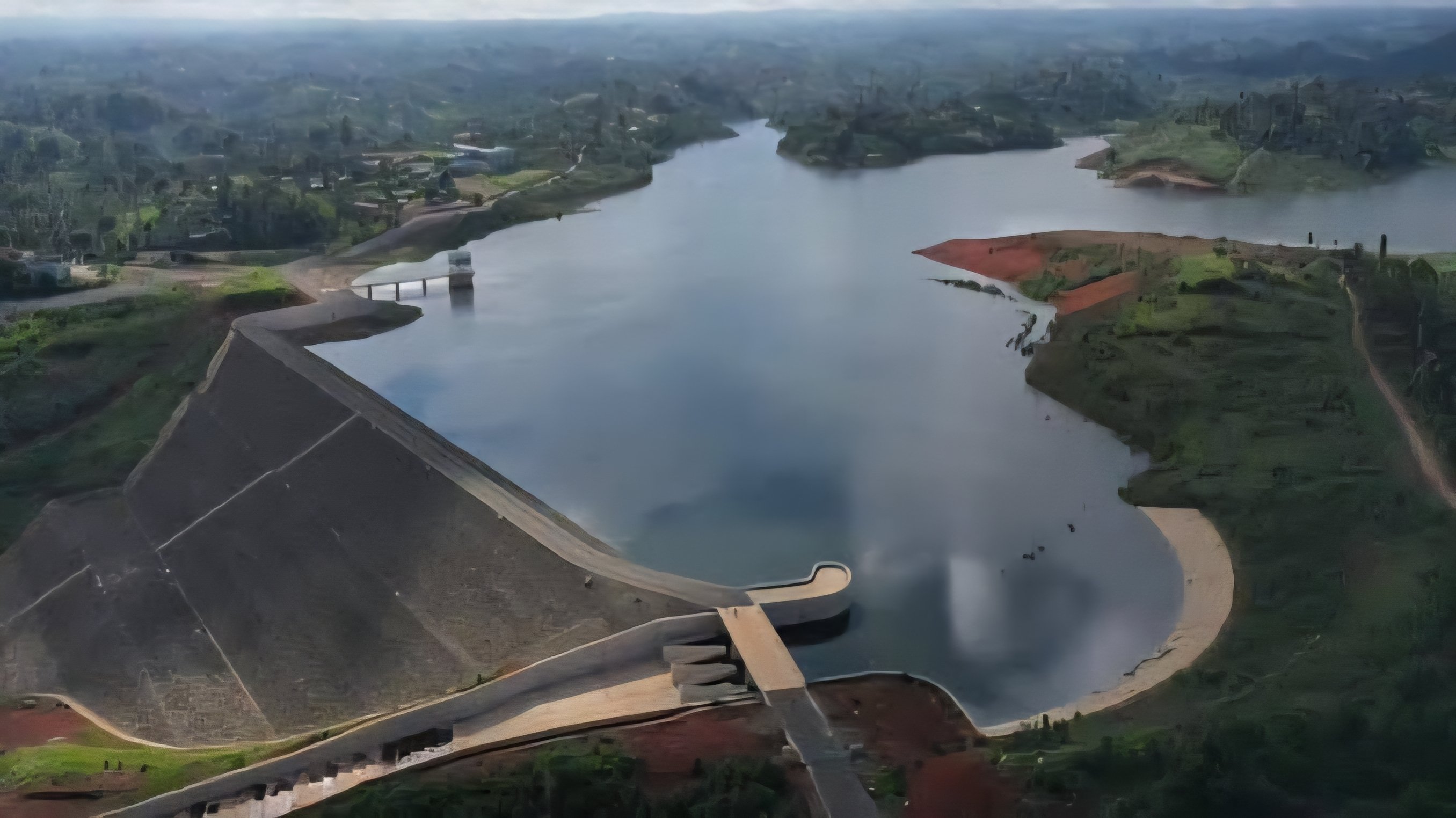 Aerial view of the Masinga Dam reservoir and spillway gates in Kenya during high water levels.