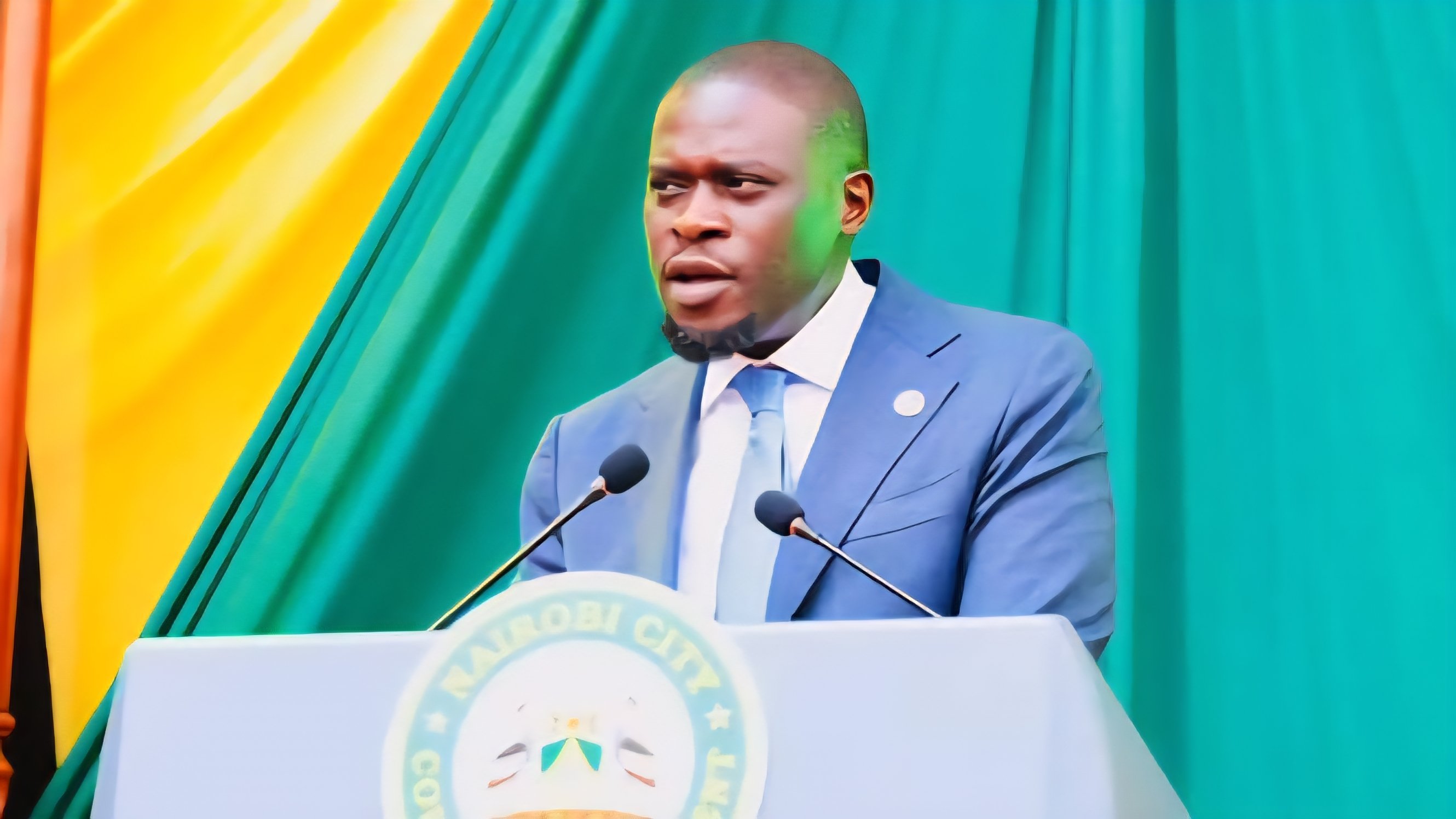 Nairobi Governor Johnson Sakaja speaking at a podium with the Kenyan flag in the background during a public address in May 2026.