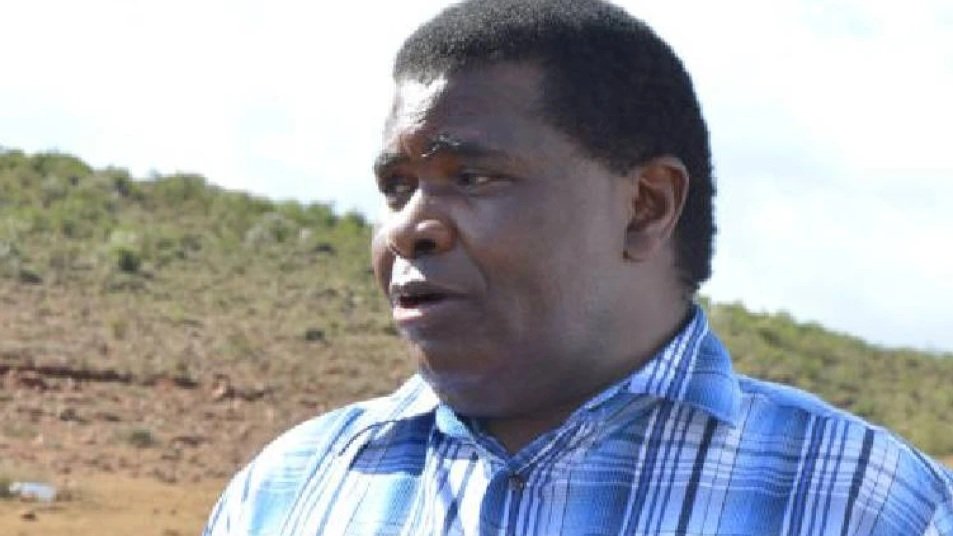 A portrait of former Limuru Member of Parliament George Nyanja addressing the press outdoors, with dry vegetation visible in the background.