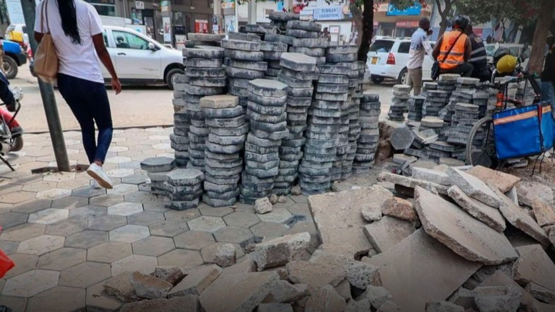 Concrete paving blocks stacked along a pedestrian walkway during construction works in Nairobi CBD