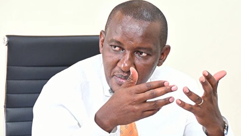 Close-up of a government official gesturing during a press briefing regarding national irrigation plans.