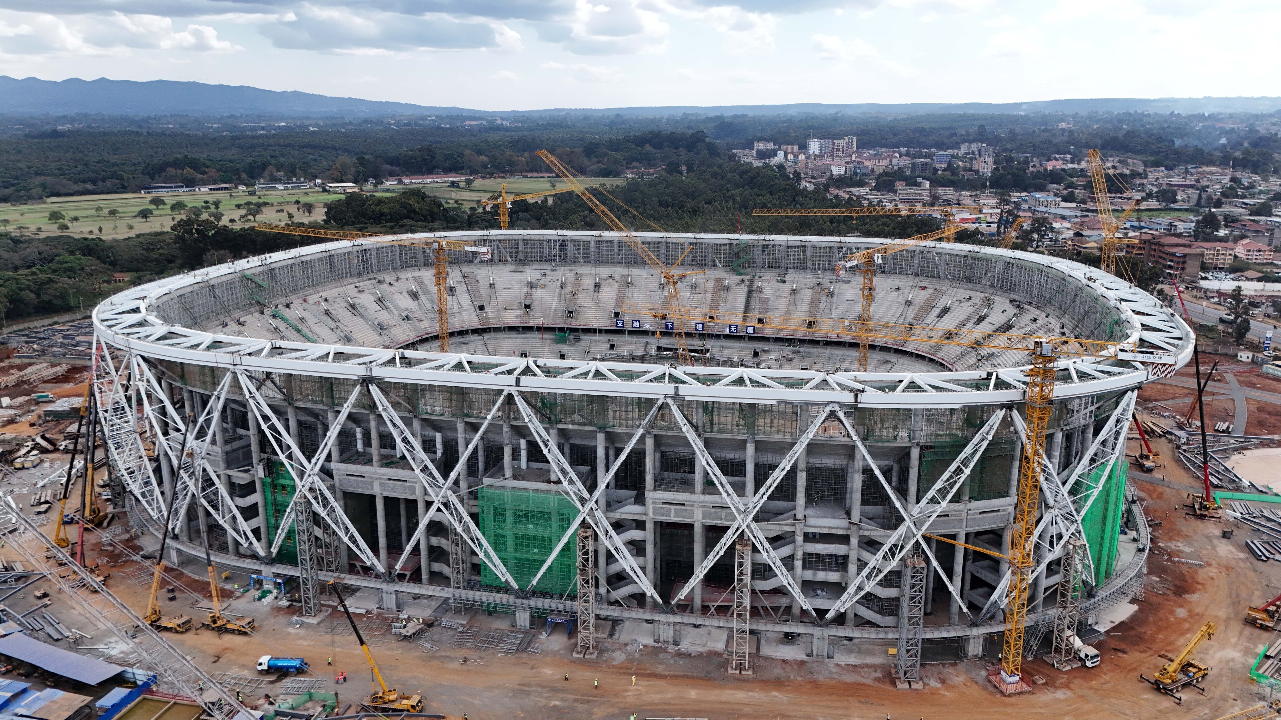 Aerial view of Talanta Sports City Stadium under construction at Jamhuri Grounds, Nairobi, showing cranes, seating tiers, and the circular structure taking shape.
