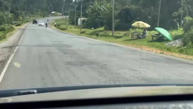 Heavy machinery and road crew working on the Kisian-Ugunja A12 road during a major Performance-Based Maintenance project