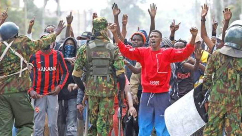 Protesters and security personnel standing on a street in Nanyuki during public demonstrations against a proposed health facility.