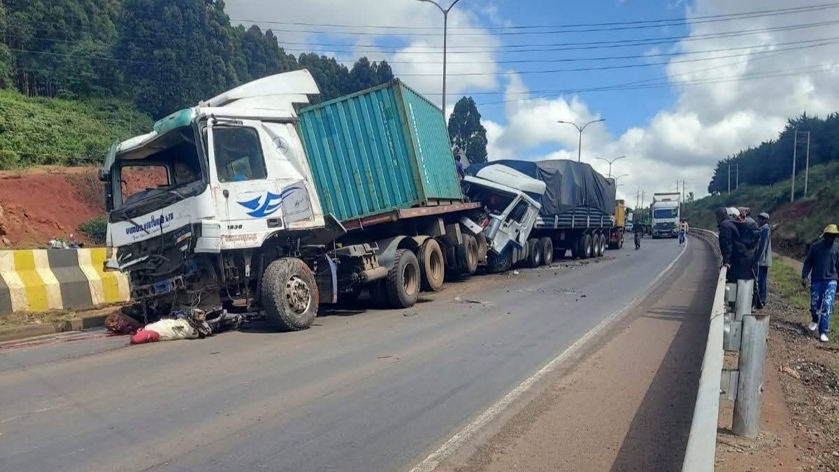 Damaged lorries at Gitaru accident scene with emergency responders and traffic congestion on the highway